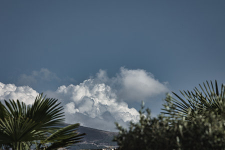 Summer holiday in the mountains, fluffy fairytale clouds over the mountainsの写真素材