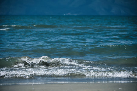 Sea Waves and Distant Mountains Under Atmospheric Haze in Vlora, Albania â August 23, 2025の写真素材