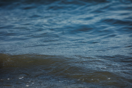 Sea Waves and Distant Mountains Under Wildfire Haze in Vlora, Albaniaの写真素材
