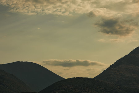 A scenic mountain landscape with rugged slopes, viewed under soft daylight.の写真素材