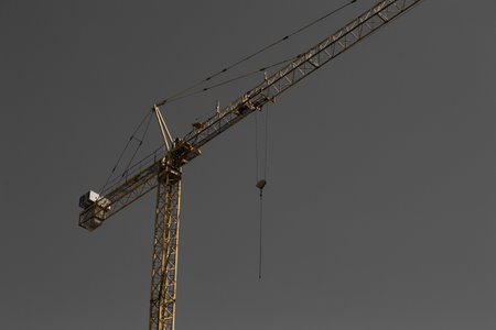 Vlora, Albania â€“ August 20, 2025: A construction crane stands against a gray sky,...