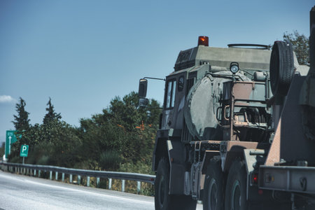 Military armored vehicles driving on a highway in Greece during a summer road journey on August 29,...