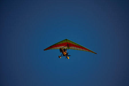 Ultralight trike aircraft flying high in a clear blue sky in Moldova 30 August 2025