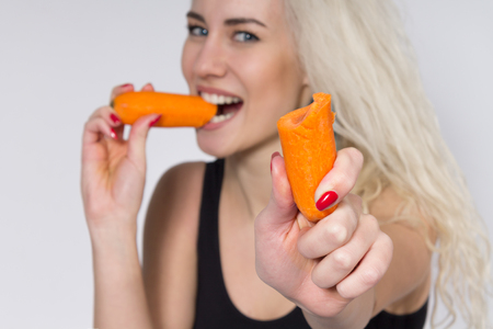 Young Woman Eating a Carrot. Vegetarianism. Dietの写真素材