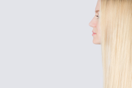 Girl with Long Blond Hair Isolated on White Backgroundの写真素材