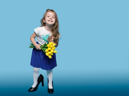 Cute Little Girl with a Bright Bouquet of Flowers Isolatedの写真素材