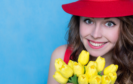 Bright Young Woman with a Bouquet of Flowers. Copy Space. Spring Conceptの写真素材