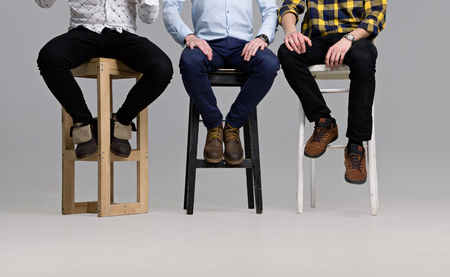 A Group of Young People Sitting on Chairs without Facesの写真素材