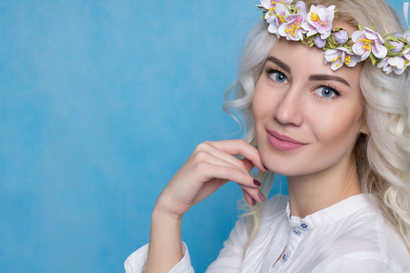 Beautiful Woman in Flower Wreath Isolated in Studio.の写真素材