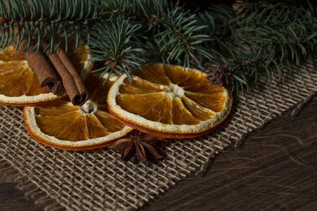 Dried Orange and Cinnamon on a Background of Treesの写真素材