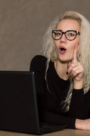 Beautiful Woman in Glasses with Computerの写真素材