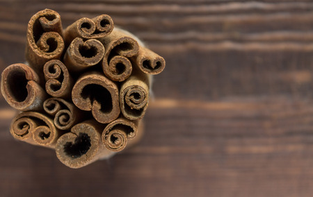 Bunch of Cinnamon Sticks on the Wooden Background. Copy Spaceの写真素材