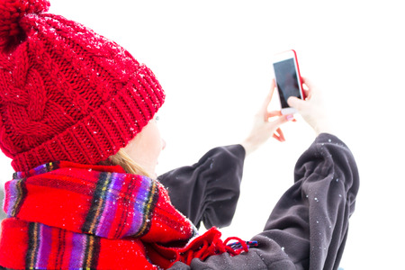 Woman in Winter Clothes Photographing Herself. Copy Space