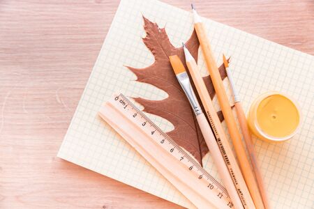 Autumn Still Life with Ruler, Brush and Pencils Wooden Backgroundの写真素材