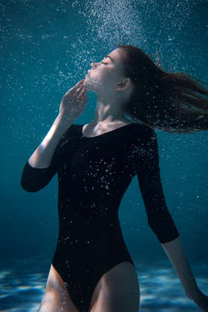 Young Slender Girl Underwater with a Cloth. Water Magic. Underwater Photography. Artの写真素材
