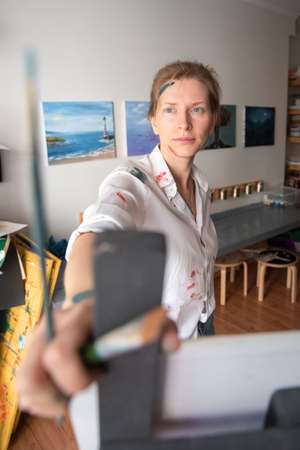 Portrait of a Woman Artist. Painting with oil paints. Creation. Copy Spaceの写真素材