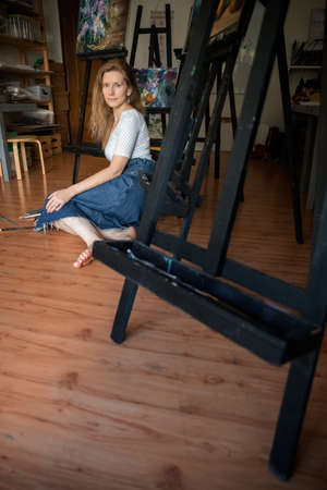 Portrait of a Woman Artist. Painting with oil paints. Creation. Copy Spaceの写真素材