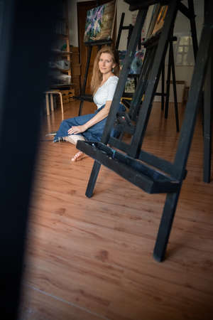 Portrait of a Woman Artist. Painting with oil paints. Creation. Copy Spaceの写真素材
