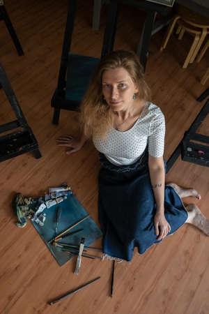 Portrait of a Woman Artist. Painting with oil paints. Creation. Copy Spaceの写真素材