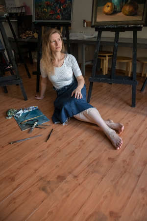 Portrait of a Woman Artist. Painting with oil paints. Creation. Copy Spaceの写真素材
