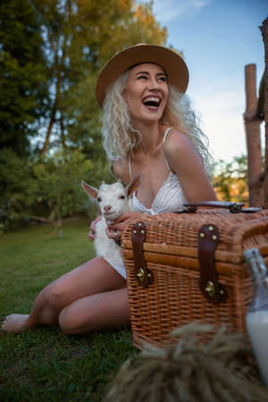 Happy Woman with Cattle on the Background Still Life with Milk and Grainの写真素材
