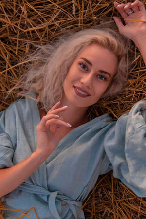 Attractive Woman in a Straw Stack. Summer Conceptの写真素材