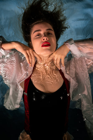 Sensual Portrait of a Young Woman in Clothes on the Water. Beauty and Fashionの写真素材