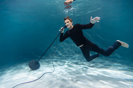Singer Man with Microphone Underwater. Copy Space. Artの写真素材
