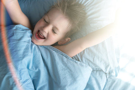 Happy Boy In Bed In The Morning. Copy Spaceの写真素材