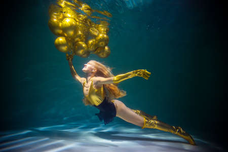 Young Beautiful Girl with Balloons under the Water. Birthday Conceptの写真素材