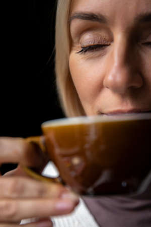 Woman with Drinks Warming Drink from a Cup. Winter Conceptの写真素材