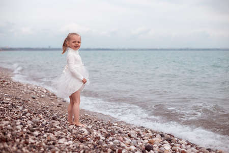 Child Girl in White Dress. Portraitの写真素材