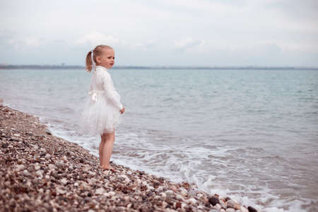 Child Girl in White Dress. Portraitの写真素材