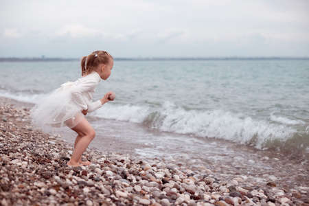 Child Girl in White Dress. Portraitの写真素材