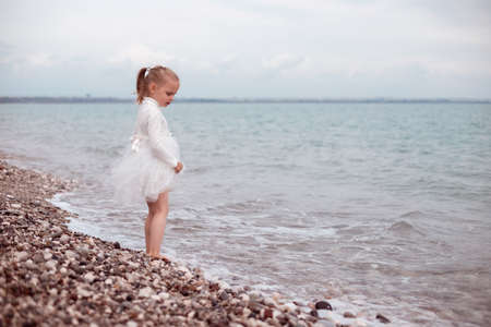 Child Girl in White Dress. Portraitの写真素材