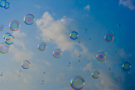 blowing soap bubbles in the sky and cloudsの写真素材