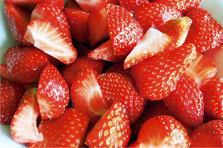 Background of delicious freshly sliced ââred strawberriesの写真素材