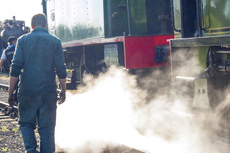 vintage steam train locomotive on railroadの写真素材