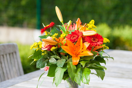 Colorful bouquet of flowers on the garden tableの写真素材