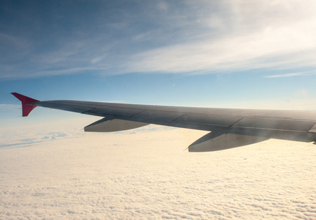view from the plane on the wing and clouds