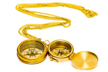 Old style gold compass with chain on white background