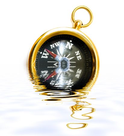 Old style brass compass with reflection on water on white backgroundの写真素材