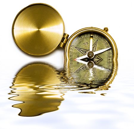 Old style brass compass with reflection on water on white backgroundの写真素材
