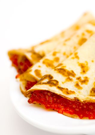 Pancakes with red caviar on a plate (Traditional russian dish)の写真素材
