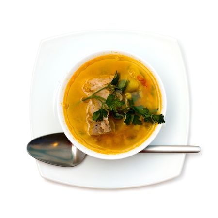 Soup with spoon isolated on whiteの写真素材