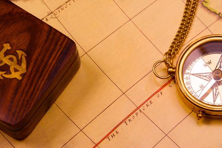 Old style brass compass on antique map   