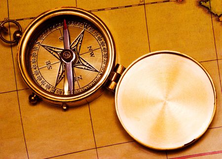 Old style brass compass on antique map   の写真素材