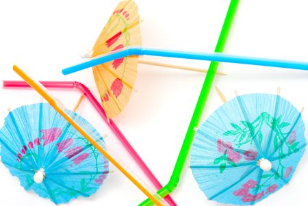 Colored straws and umbrellas isolated on white backgroundの写真素材
