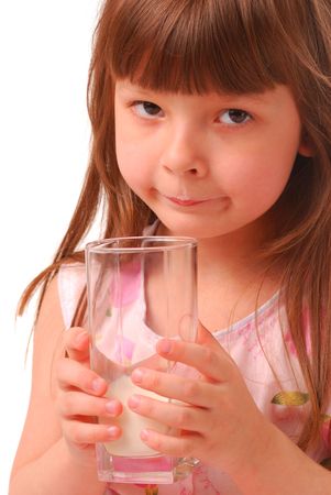 Girl with milk-moustache holding glass of milk, over white           の写真素材
