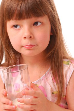 Girl with milk-moustache holding glass of milk, over white           の写真素材